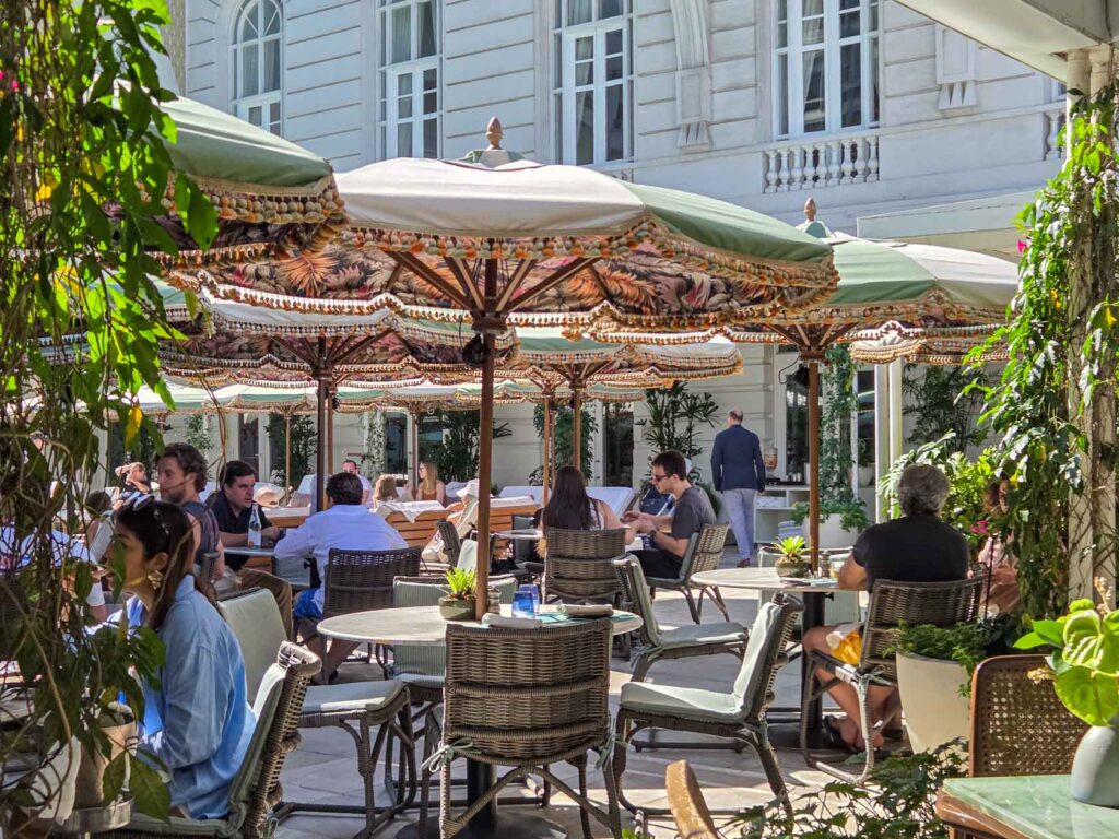 Chic poolside scene with striped umbrellas at Belmond Copacabana Palace, one of the top luxury hotels in Rio de Janeiro ©Stephanie Dosch | theViatrix Luxury Travel