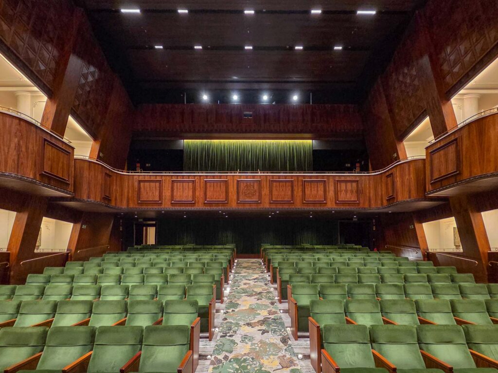 Historic theater with green velvet seats and wood-paneled balconies at Belmond Copacabana Palace, a luxury hotel in Rio de Janeiro ©Stephanie Dosch | theViatrix Luxury Travel