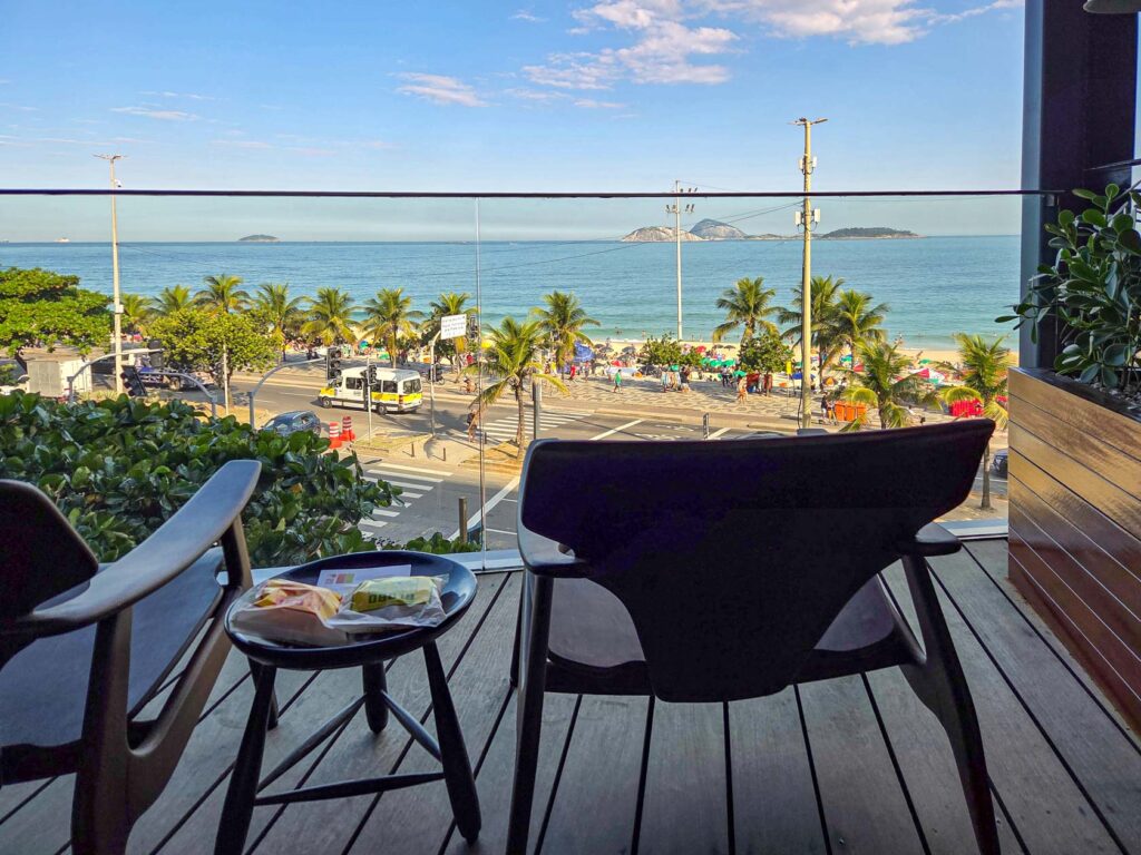 Balcony seating with oceanfront view of Ipanema Beach at Hotel Fasano, a top luxury hotel in Rio de Janeiro ©Stephanie Dosch | theViatrix Luxury Travel