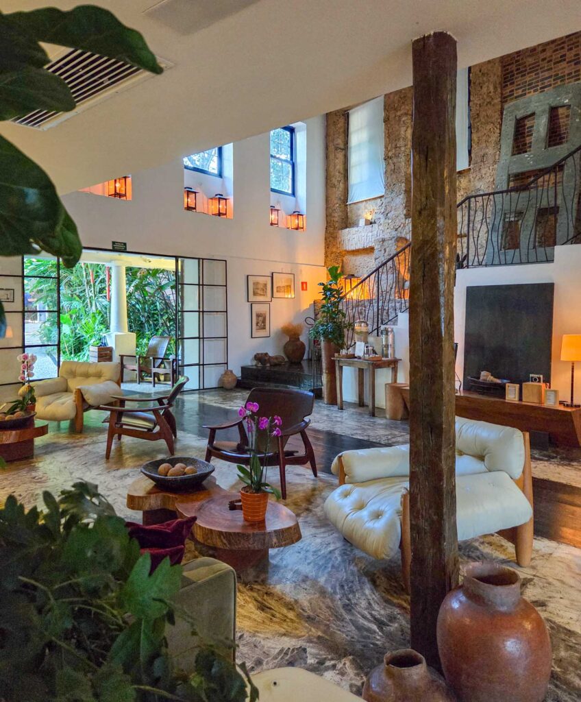 Eclectic lobby with rustic stone walls and tropical light at Santa Teresa Hotel RJ - MGallery, a boutique luxury hotel in Rio de Janeiro ©Stephanie Dosch | theViatrix Luxury Travel