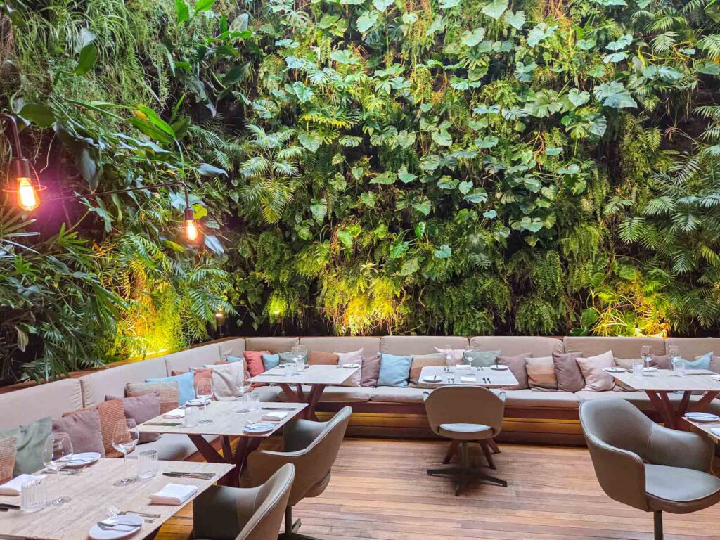 Indoor restaurant framed by lush living wall at Emiliano Rio, a design-forward luxury hotel in Rio de Janeiro ©Stephanie Dosch | theViatrix Luxury Travel